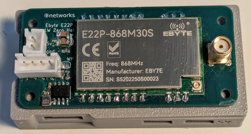 Picture of the hat on top of a Pi Zero, showing a radio module and an antenna connector.